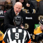 Boston Bruins head coach Jim Montgomery argues with officials during the first period of an NHL hockey game against the Florida Panthers, Monday, Oct. 14, 2024, in Boston.