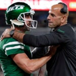 Jets quarterback Aaron Rodgers talks with coach Robert Saleh during a game against the Patriots.