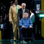 Bob Cousy enters the court during the championship banner raising at TD Garden.
