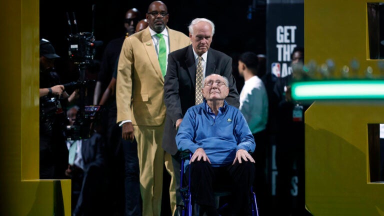 Bob Cousy enters the court during the championship banner raising at TD Garden.