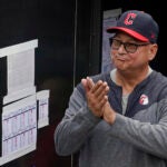 Cleveland Guardians manager Terry Francona applauds during a tribute video before the team's baseball game against the Cincinnati Reds.