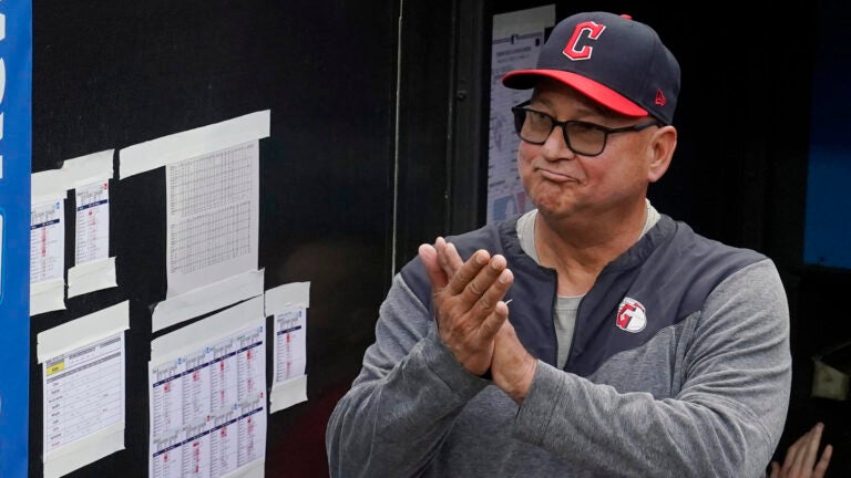 Cleveland Guardians manager Terry Francona applauds during a tribute video before the team's baseball game against the Cincinnati Reds.