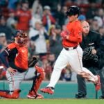 Masataka Yoshida scores in front of Twins' Christian Vázquez on a single by Connor Wong.