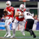 New England Patriots center Ben Brown (77) holds off Houston Texans defensive tackle Folorunso Fatukasi (91) as New England Patriots quarterback Drake Maye (10) looks to throw during the second quarter at Gillette Stadium.