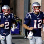 New England Patriots quarterbacks Brian Hoyer, left, and Tom Brady head to the field to warm up before an NFL football game against the Kansas City Chiefs in 2018. (Bill Sikes/AP)