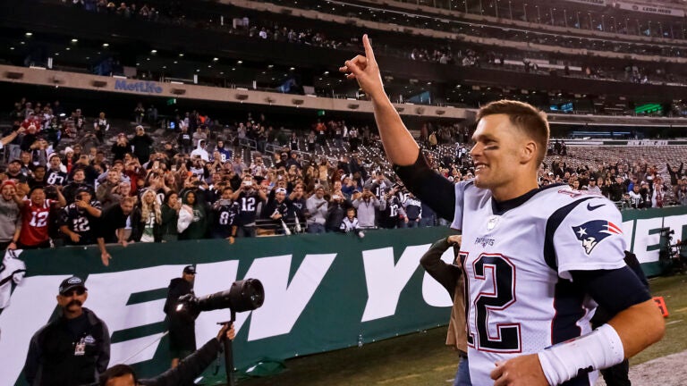 New England Patriots Tom Brady acknowledges the fans after they defeated the New York Jets 33-0 at MetLife Stadium.