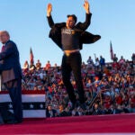 Elon Musk throws his hands in the air and jumps while attending a campaign rally for former President Donald Trump, the Republican presidential nominee, in Butler, Pa., Oct. 5, 2024. The richest man in the world has involved himself in the U.S. election in a manner unparalleled in modern history: Musk is going all in to elect Trump.