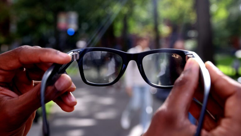 Caine Ardayfio holds up the smart glasses.