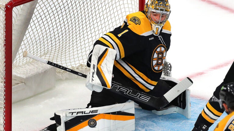 Bruins goalie Jeremy Swayman makes a pad save in the first period.