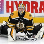 Boston Bruins goaltender Jeremy Swayman (1) stretches during pregame warmups.