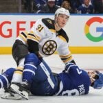 TORONTO, CANADA - NOVEMBER 5: Nikita Zadorov #91 of the Boston Bruins takes down Max Pacioretty #67 ofthe Toronto Maple Leafs during the second period in an NHL game at Scotiabank Arena on November 5, 2024 in Toronto, Ontario, Canada.