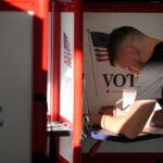 A voter fills out their their ballot in Fall River, Mass.