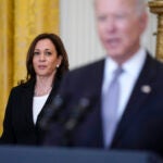 Vice President Kamala Harris listens as President Joe Biden speaks.