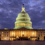 Lights shine inside the U.S. Capitol Building as night falls on Jan. 21, 2018, in Washington.