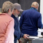 A person submits his ballot on Election Day.