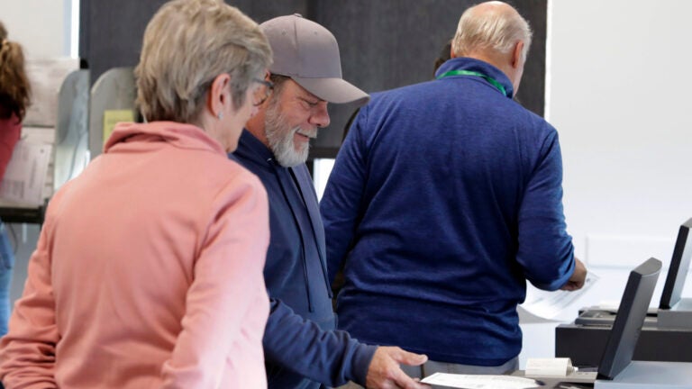 A person submits his ballot on Election Day.