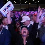 Supporters watch returns at a campaign election night watch party for Republican presidential nominee former President Donald Trump at the Palm Beach Convention Center.