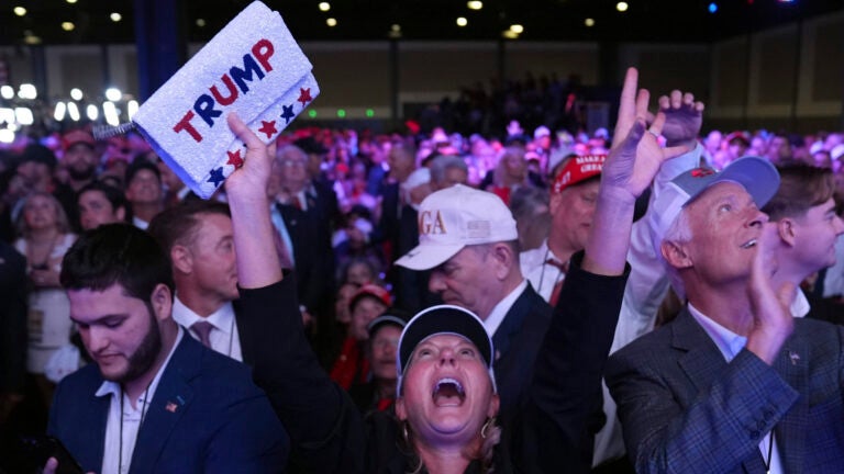 Supporters watch returns at a campaign election night watch party for Republican presidential nominee former President Donald Trump at the Palm Beach Convention Center.