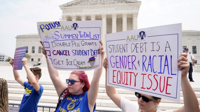 People demonstrate outside the Supreme Court.
