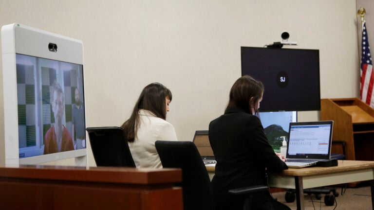 Jason Eaton is seen on a monitor.