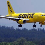 A Spirit Airlines 319 Airbus approaches Manchester Boston Regional Airport for a landing.