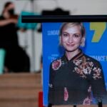 A musician plays a violin behind a photograph of cinematographer Halyna Hutchins during a vigil.