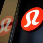 The Lululemon logo is displayed on a Lululemon store in Pittsburgh.