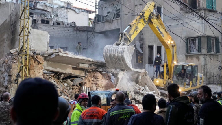 Rescuers use an excavator.