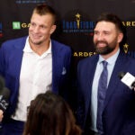 Former New England Patriots Rob Gronkowski, left, and Rob Ninkovich talk to reporters during “The Tradition,” the Sports Museum’s fundraising gala, at TD Garden. Ninkovich is presenting Gronkowski with the Football Legacy award.