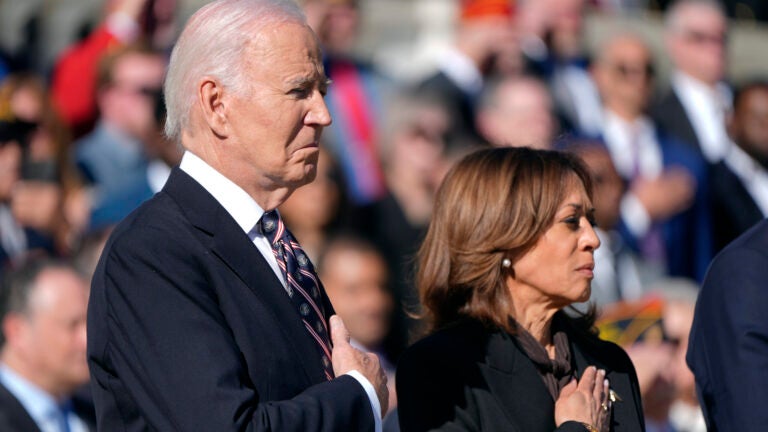 President Joe Biden, left, and Vice President Kamala Harris look on during a wreath laying ceremony at the Tomb of the Unknown Soldier on National Veterans Day Observance at Arlington National Cemetery in Arlington, Va., Monday, Nov. 11, 2024.
