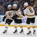 The Bruins' David Pastrnak, left, is congratulated by Charlie McAvoy (73) and Mason Lohrei (6) after scoring during the third period.