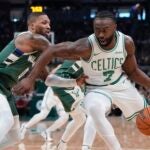 Boston Celtics' Jaylen Brown tries to get past Milwaukee Bucks' Damian Lillard during the first half of an NBA basketball game Sunday, Nov. 10, 2024, in Milwaukee.