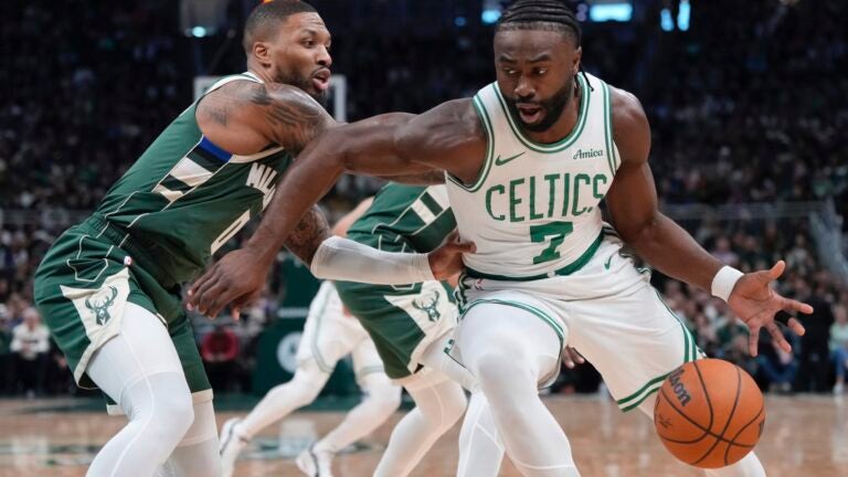 Boston Celtics' Jaylen Brown tries to get past Milwaukee Bucks' Damian Lillard during the first half of an NBA basketball game Sunday, Nov. 10, 2024, in Milwaukee.