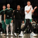 Kristaps Porzingis claps for his teammates during a game against the Nets.