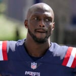 New England Patriots cornerback Jason McCourty stands on the sideline in the first half of an NFL football game against the Miami Dolphins, Sunday, Sept. 13, 2020, in Foxborough, Mass.