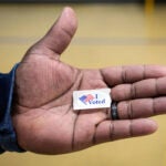 Sasha Dix shows his "I voted" sticker after he voted at TC Roberson High School on Tuesday, Nov. 5, 2024, in Asheville, N.C.
