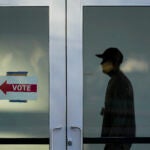 A poll worker monitors voting at a polling place on the Arizona State University campus, Tuesday, Nov. 5, 2024, in Phoenix.