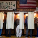 Voters mark their ballots at a polling place, Tuesday, Nov. 5, 2024, in Mitchell, Wis.