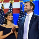 Republican vice presidential nominee Sen. JD Vance smiles as his wife, Usha Vance, applauds as Republican presidential nominee former President Donald Trump speaks at an election night watch party at the Palm Beach Convention Center, Wednesday, Nov. 6, 2024, in West Palm Beach, Fla.