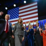 Republican presidential nominee former President Donald Trump gestures as he walks with former first lady Melania Trump at an election night watch party at the Palm Beach Convention Center, Wednesday, Nov. 6, 2024, in West Palm Beach, Fla.