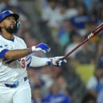 Los Angeles Dodgers' Teoscar Hernandez watches the flight of the ball that went foul during a baseball game against the Seattle Mariners, Tuesday, Aug. 20, 2024, in Los Angeles.
