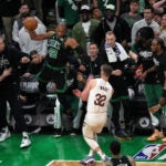 Celtics center Al Horford goes airborne into the crowd to save an out of bounds ball and throws it at Cavaliers forward Dean Wade.