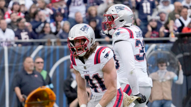 New England Patriots safety Brenden Schooler (41) celebrates his sack of Chicago Bears quarterback Caleb Williams with Anfernee Jennings during the second half of an NFL football game Sunday, Nov. 10, 2024, in Chicago.