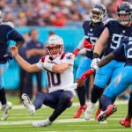 Drake Maye slides after a run against the Titans.