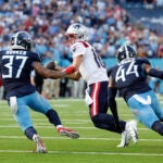 Drake Maye scrambles late in the fourth quarter at Nissan Stadium.
