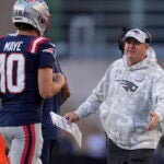 New England Patriots offensive coordinator Alex Van Pelt talks with Drake Maye during the second half of an NFL football game against the Los Angeles Rams, Sunday, Nov. 17, 2024, in Foxborough, Mass.