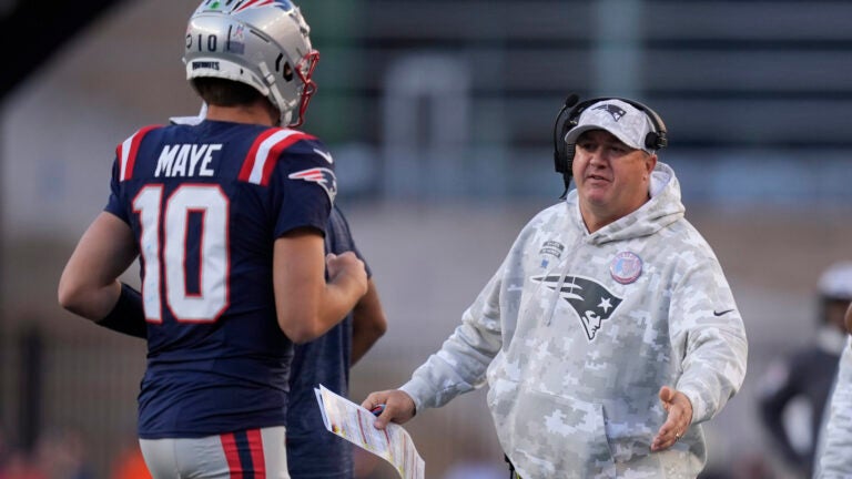 New England Patriots offensive coordinator Alex Van Pelt talks with Drake Maye during the second half of an NFL football game against the Los Angeles Rams, Sunday, Nov. 17, 2024, in Foxborough, Mass.