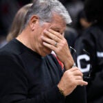 Geno Auriemma reacts as former player Diana Taurasi speaks as he is honored for the most wins in college basketball history.