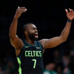 Boston Celtics guard Jaylen Brown (7) reacts after making a 3-point basket during the second quarter at TD Garden.