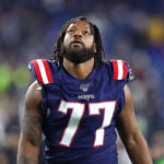 Michael Bennett look up at the stands in pregame warmups.